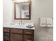Bathroom featuring a modern sink, a marble countertop, and dark wood cabinets at 4616 Gold Finch Dr, Denver, NC 28037