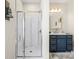 Bright bathroom featuring a modern shower and a blue vanity with ample storage at 4616 Gold Finch Dr, Denver, NC 28037