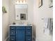 Bathroom boasts a blue vanity with white countertop and a well-lit mirror at 4616 Gold Finch Dr, Denver, NC 28037