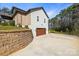Home with a brick and white exterior, three car garage and concrete driveway at 4616 Gold Finch Dr, Denver, NC 28037