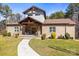Inviting front exterior featuring a beautiful stone facade, well-manicured lawn, and a charming walkway at 4616 Gold Finch Dr, Denver, NC 28037