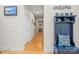 Hallway featuring a blue cushioned bench, wood floors, and light-colored walls at 4616 Gold Finch Dr, Denver, NC 28037