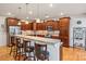 Well-equipped kitchen featuring dark wood cabinetry, stainless steel appliances, and a breakfast bar at 4616 Gold Finch Dr, Denver, NC 28037