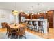 Eat-in kitchen features a breakfast bar, wood cabinets, stainless refrigerator and hardwood floors at 4616 Gold Finch Dr, Denver, NC 28037