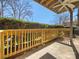 Outdoor balcony with wood railing, concrete floor, and green plants on a sunny day at 4918 Sardis Rd # E, Charlotte, NC 28270