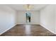 Bright bedroom featuring wood floors, a ceiling fan, and a large window at 4918 Sardis Rd # E, Charlotte, NC 28270