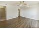 Spacious bedroom featuring wood floors, a ceiling fan, and two entryways at 4918 Sardis Rd # E, Charlotte, NC 28270