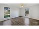 Bright bedroom with hardwood floors and two windows providing ample natural light at 4918 Sardis Rd # E, Charlotte, NC 28270