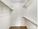 Walk-in closet with wood floors and built-in shelving at 4918 Sardis Rd # E, Charlotte, NC 28270