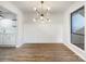 The dining room features wood floors, wainscoting, a modern light fixture, and a large window at 4918 Sardis Rd # E, Charlotte, NC 28270