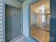 Condo entrance featuring a solid door with a view inside of a living room with hardwood floors and dining area at 4918 Sardis Rd # E, Charlotte, NC 28270