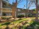 Attractive condo building with balconies and mature trees offering a serene outdoor setting at 4918 Sardis Rd # E, Charlotte, NC 28270