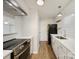 Modern kitchen featuring stainless steel appliances, white cabinets, granite countertops, and hardwood floors at 4918 Sardis Rd # E, Charlotte, NC 28270