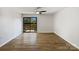 Bright living room with wood floors and sliding glass doors to a private balcony at 4918 Sardis Rd # E, Charlotte, NC 28270