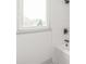 Clean bathroom with white tile, bathtub and window at 6535 Fisher Farm Nw Ln, Concord, NC 28027