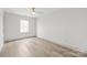 Well-lit bedroom with neutral walls and laminate floors offers a cozy atmosphere at 6535 Fisher Farm Nw Ln, Concord, NC 28027