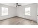 Bright bedroom with laminate floors and two large windows at 6535 Fisher Farm Nw Ln, Concord, NC 28027