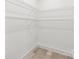 Walk-in closet featuring hardwood floors, white walls, base trim and wire rack shelving at 6535 Fisher Farm Nw Ln, Concord, NC 28027