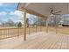 Spacious wooden deck with a ceiling fan and an open backyard view at 6535 Fisher Farm Nw Ln, Concord, NC 28027