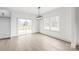 Dining area featuring hardwood floors, natural light, modern lighting, and view of the deck from the sliding door at 6535 Fisher Farm Nw Ln, Concord, NC 28027