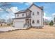 Beautiful two-story home featuring a two-car garage, stone accents, manicured landscaping, and a welcoming front entrance at 6535 Fisher Farm Nw Ln, Concord, NC 28027