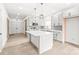 Bright, modern kitchen featuring an island, stainless steel appliances, shaker cabinets, and gray subway tile backsplash at 6535 Fisher Farm Nw Ln, Concord, NC 28027