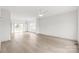 Bright and airy living room featuring hardwood floors, modern lighting, neutral paint, and slider leading to deck at 6535 Fisher Farm Nw Ln, Concord, NC 28027