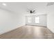 Large main bedroom featuring hardwood floors, neutral paint, large windows, and a modern ceiling fan at 6535 Fisher Farm Nw Ln, Concord, NC 28027