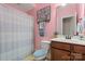 A pink bathroom featuring cherry blossom art, a shower with curtain and blue accents at 7205 Yellowhorn Trl, Waxhaw, NC 28173