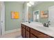 Well-lit bathroom with double vanity and light green walls at 7205 Yellowhorn Trl, Waxhaw, NC 28173