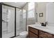 Bathroom with dark fixtures, and a full-size shower with glass doors at 7205 Yellowhorn Trl, Waxhaw, NC 28173