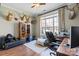 Bedroom with a chair, desk, and large windows offering natural light and a comfortable workspace at 7205 Yellowhorn Trl, Waxhaw, NC 28173