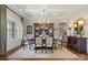 Elegant dining room with hardwood floors, coffered ceilings, and decorative chandelier at 7205 Yellowhorn Trl, Waxhaw, NC 28173