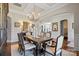 Bright dining room featuring a chandelier, hardwood floors, and stylish decor at 7205 Yellowhorn Trl, Waxhaw, NC 28173