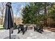 A brick fire pit with Adirondack chairs set in the landscaped backyard at 7205 Yellowhorn Trl, Waxhaw, NC 28173