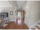 Spacious foyer with hardwood floors, neutral paint, and a front door with decorative glass at 7205 Yellowhorn Trl, Waxhaw, NC 28173