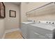 Functional laundry room with a washer, dryer, wire shelving and neutral wall color at 7205 Yellowhorn Trl, Waxhaw, NC 28173