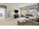 Comfortable living area features a large sofa, TV, and neutral color palette at 7205 Yellowhorn Trl, Waxhaw, NC 28173