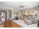Open-concept living room with hardwood floors, comfortable seating, and a view of the kitchen at 7205 Yellowhorn Trl, Waxhaw, NC 28173
