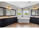 Modern main bathroom featuring dual vanities, garden tub, and large windows at 7205 Yellowhorn Trl, Waxhaw, NC 28173