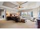Spacious main bedroom with decorative ceiling, ceiling fan, and sitting area at 7205 Yellowhorn Trl, Waxhaw, NC 28173