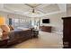A large main bedroom has tray ceiling, ceiling fan, and lots of windows at 7205 Yellowhorn Trl, Waxhaw, NC 28173
