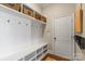 Mudroom area with built-in shelves, hooks, and bench seating providing a practical and organized space at 7205 Yellowhorn Trl, Waxhaw, NC 28173