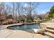 Backyard pool with built-in spa, and outdoor kitchen with grill and dining area at 7205 Yellowhorn Trl, Waxhaw, NC 28173