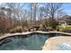 L-shaped in-ground pool with a backyard kitchen and dining area at 7205 Yellowhorn Trl, Waxhaw, NC 28173
