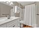 This bathroom features a vanity with storage and a shower-tub combo at 7214 Quail Meadow Ln, Charlotte, NC 28210