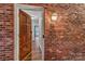 Exterior view of entrance featuring a brick facade and wood door at 7214 Quail Meadow Ln, Charlotte, NC 28210