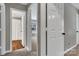 Hallway with multiple white doors, gray walls, and views into rooms at 7214 Quail Meadow Ln, Charlotte, NC 28210