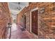 Hallway featuring brick walls, exterior doors and unique flooring at 7214 Quail Meadow Ln, Charlotte, NC 28210