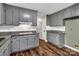 Renovated kitchen features gray cabinets, granite countertops, and a subway tile backsplash at 7214 Quail Meadow Ln, Charlotte, NC 28210
